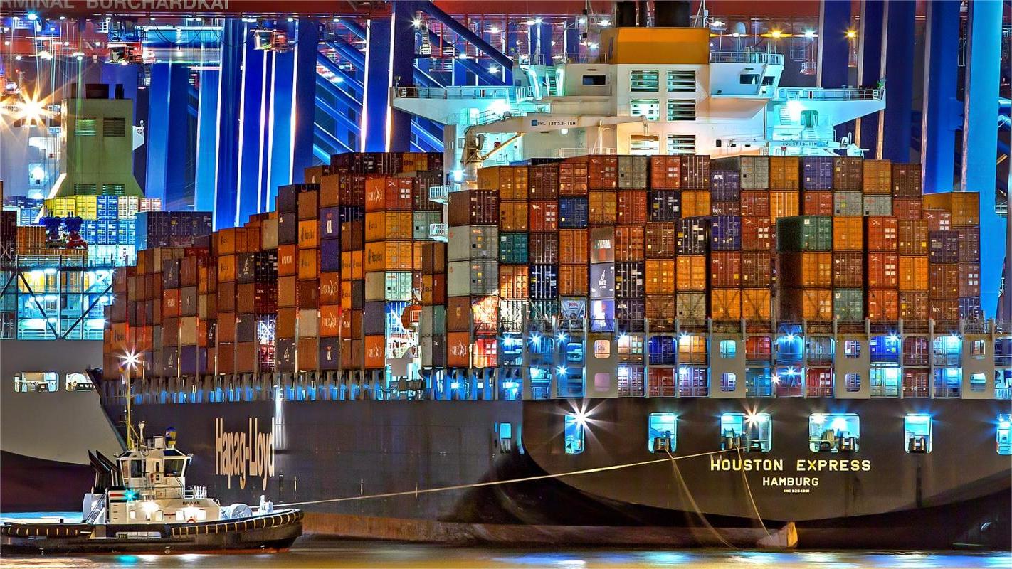 Shipping containers at a busy port with a US flag and Thailand flag